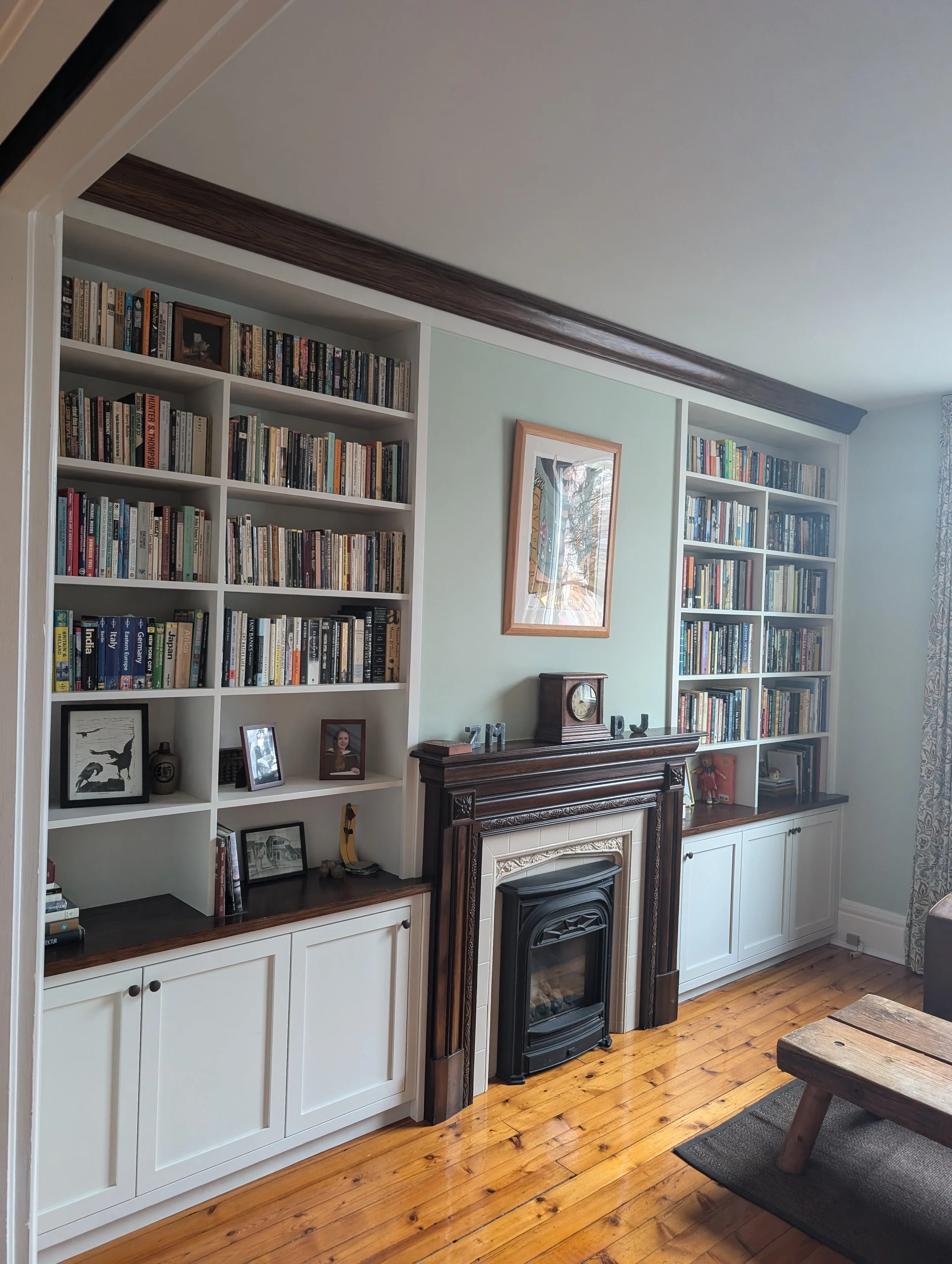 Custom built-in bookshelves and millwork integrated into a residential living room, designed and fabricated by Parallel Studios.