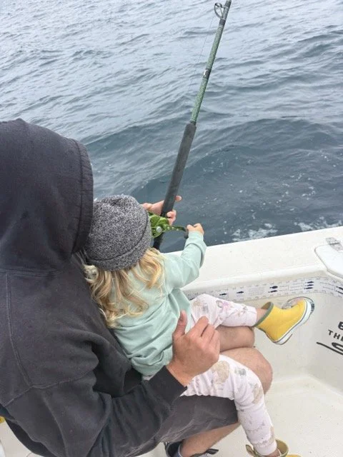 Zoey reeling in a bass.jpeg