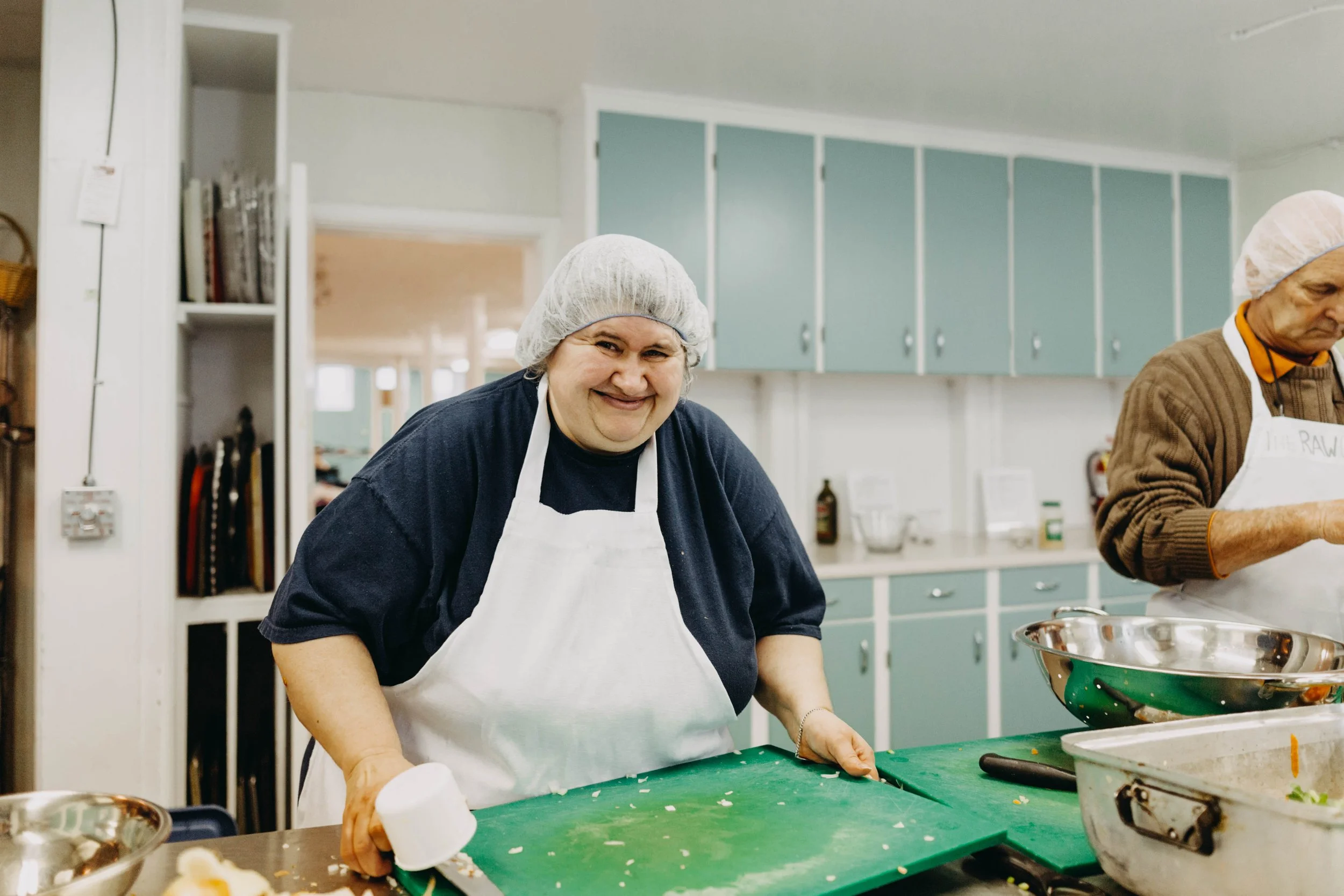 Staff preparing soup in kitchen.