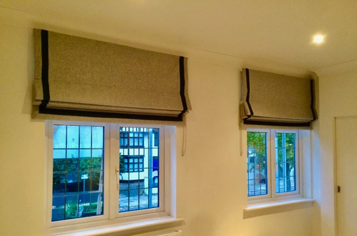 Handmade bespoke black out roman blinds with inset border in wool from Romo & linen from The Cloth Shop.