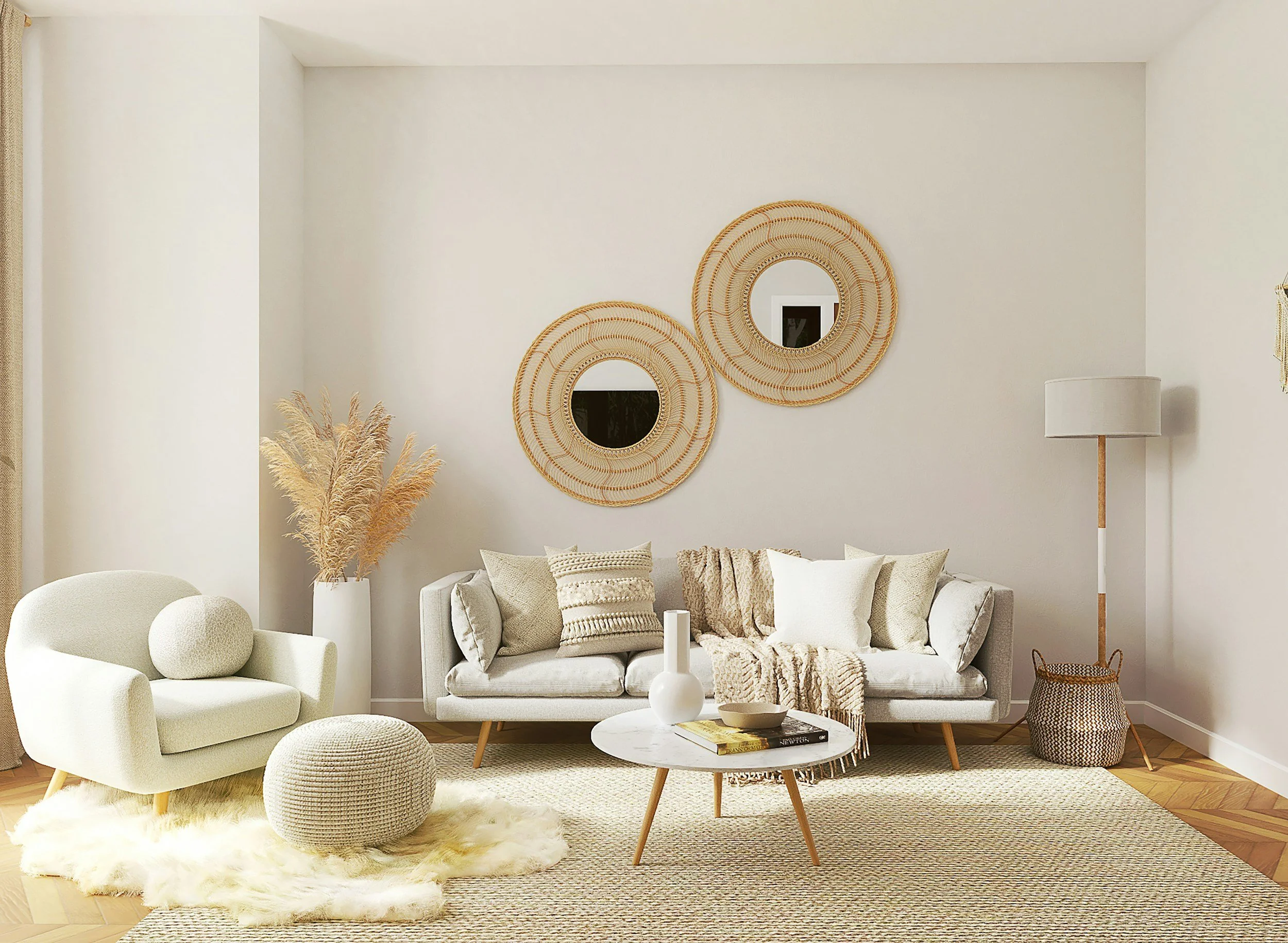 A living room with a white armchair, a beige sofa, and a round marble coffee table. Decor includes a white vase with pampas grass, wall mirrors, and a floor lamp. Neutral tones and cozy textiles are used.
