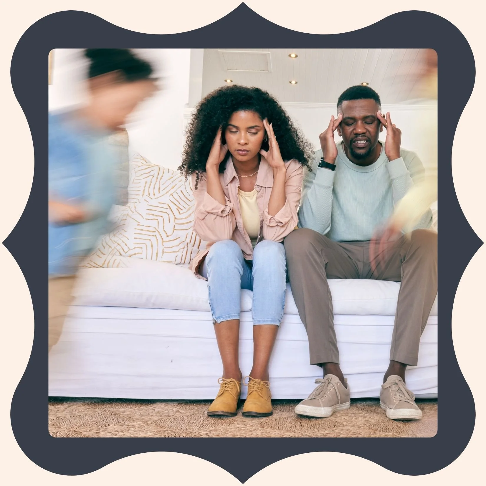 Two people sitting on a couch with their eyes closed, touching their temples, appearing to meditate or relax. A third person is blurred in motion walking past them.