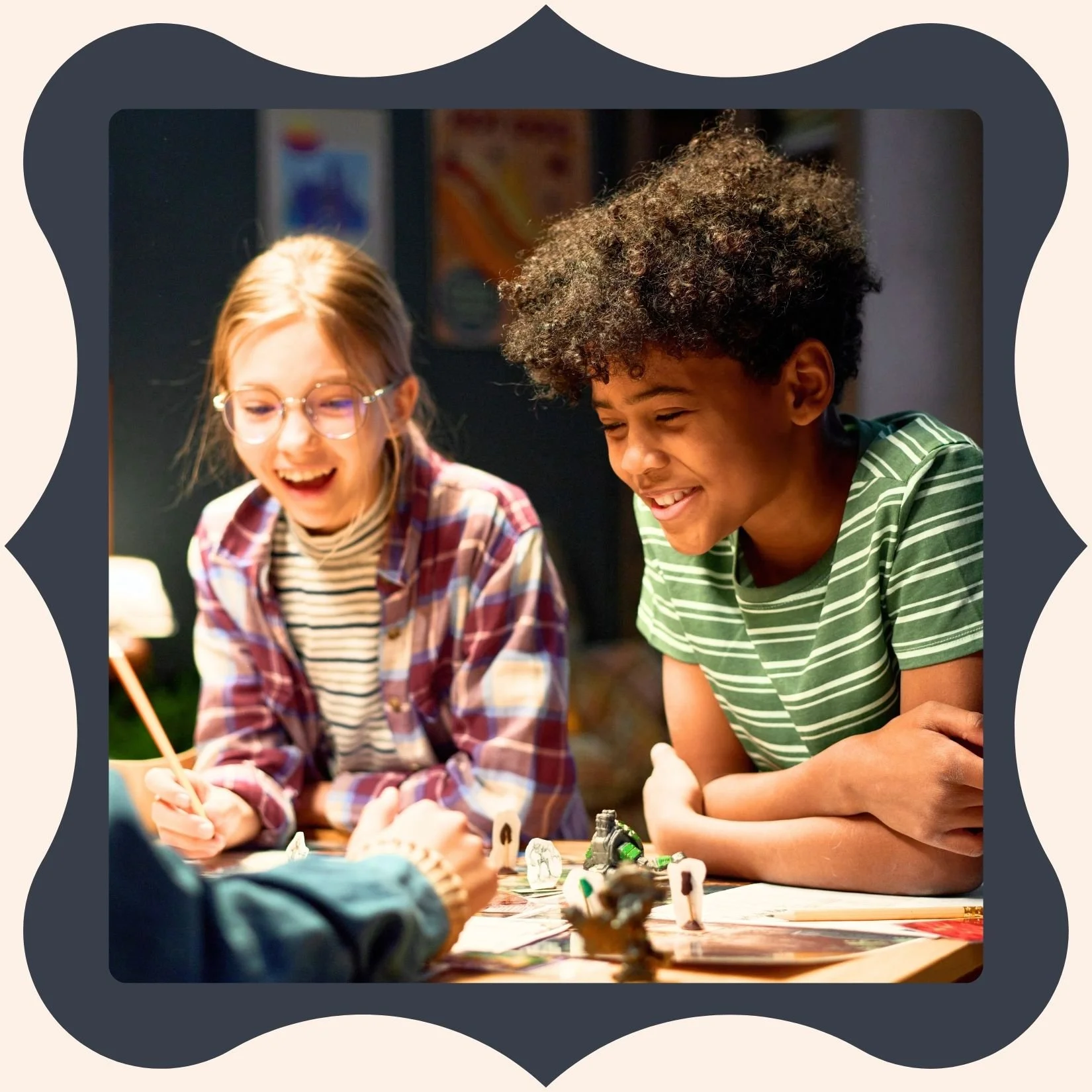 Two children, a girl with glasses and a boy with curly hair, are playing a tabletop game together, smiling and enjoying themselves.