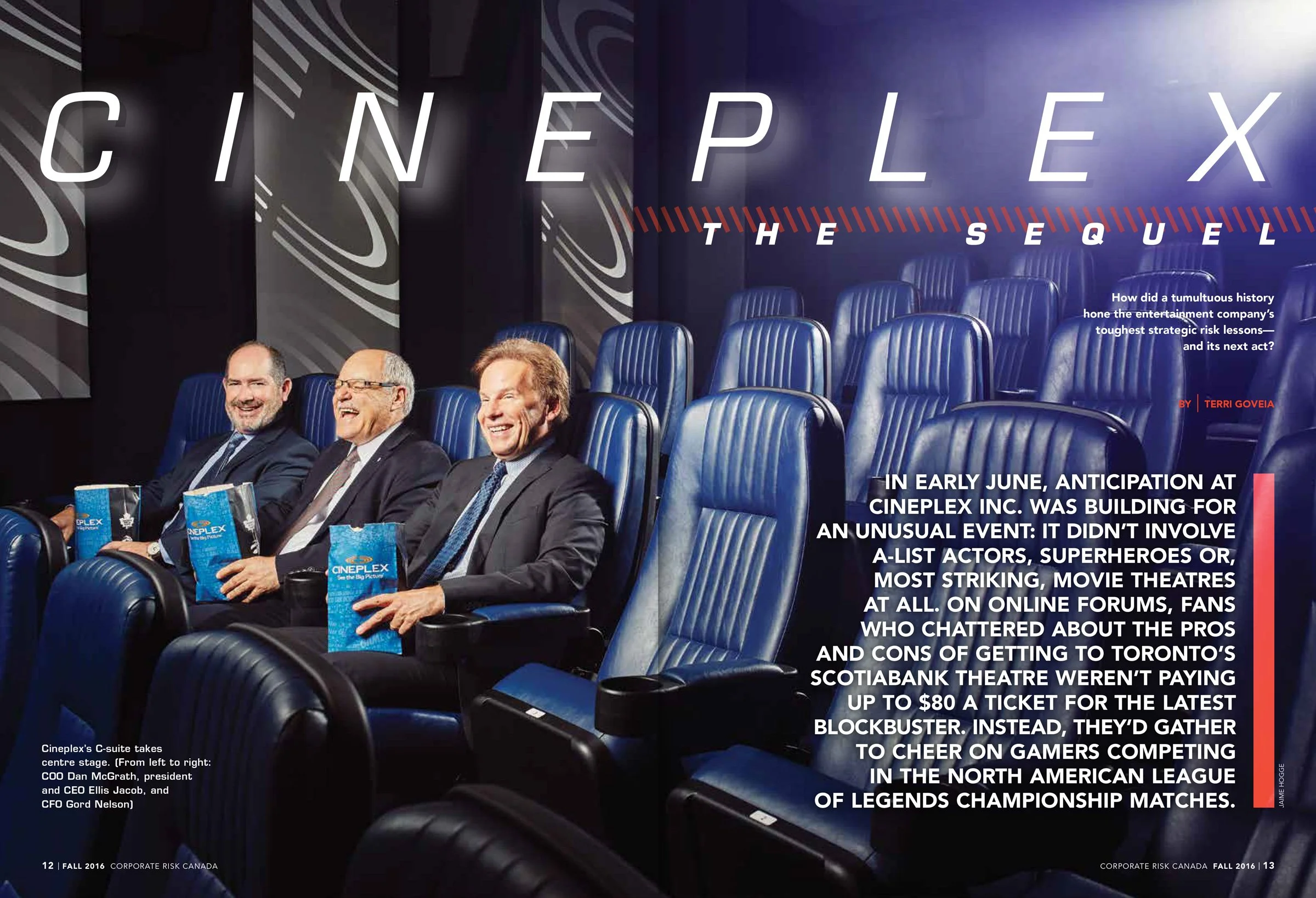 Interior magazine spread showing senior executives in a corporate setting, photographed in a private theatre environment.