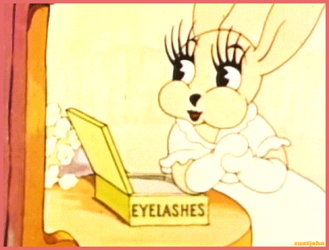 A cartoon rabbit looking at a mirror with false eyelashes in a box labeled 'Eyelashes'.