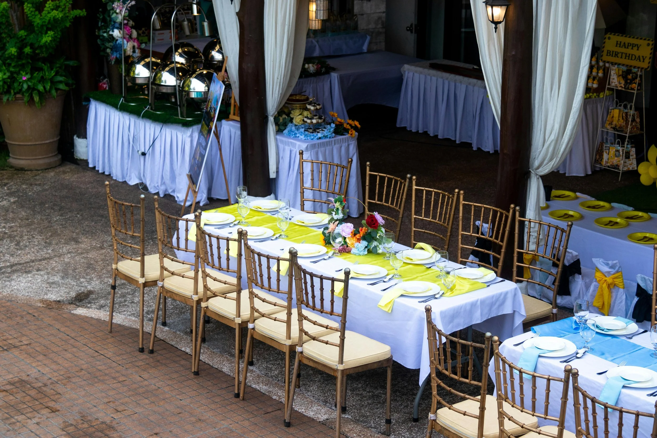 Outdoor birthday party with formal dining tables representing the social pressure of eating at celebrations when you have food sensitivities