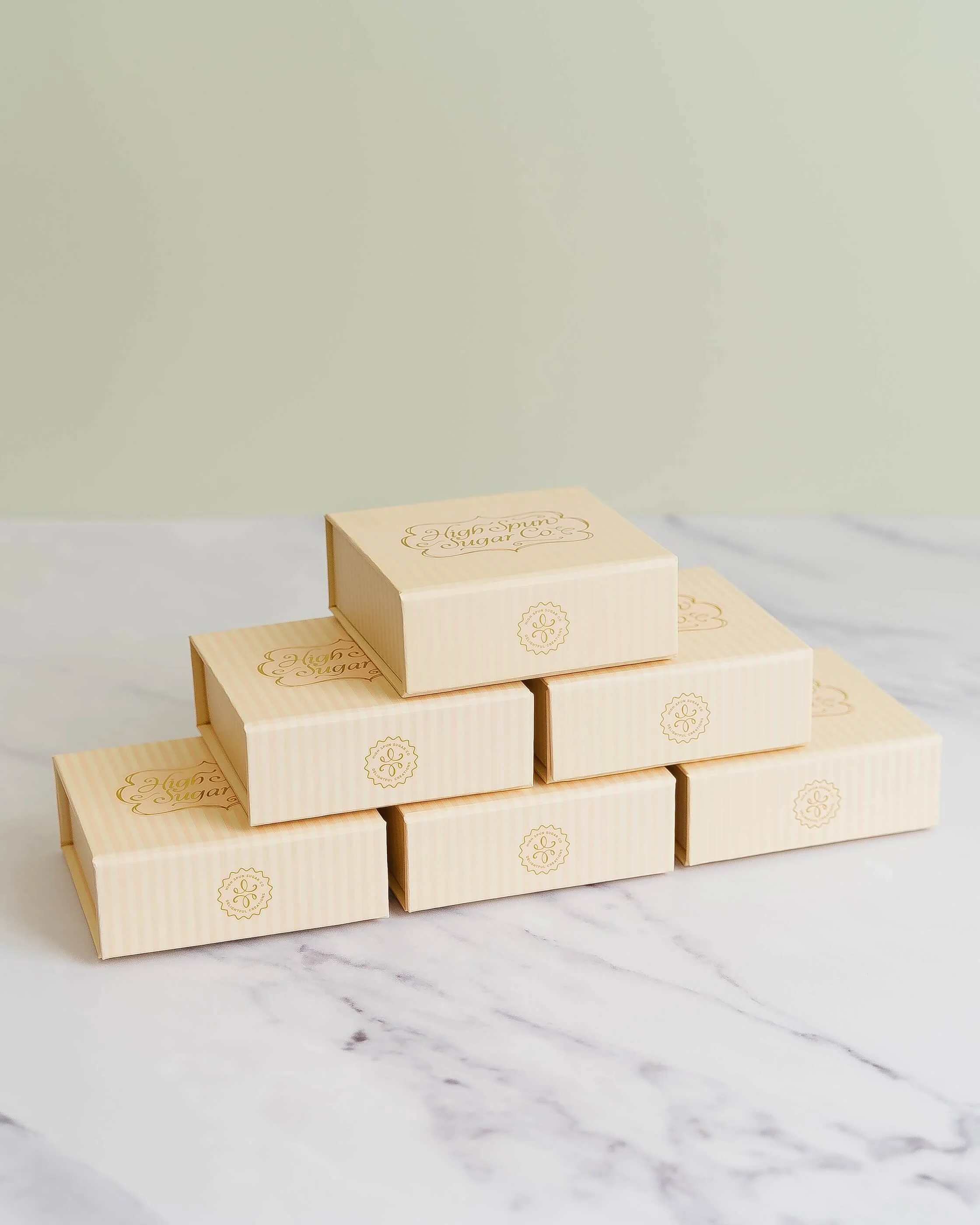 Stacked, beige bite-sized boxes before an olive green background