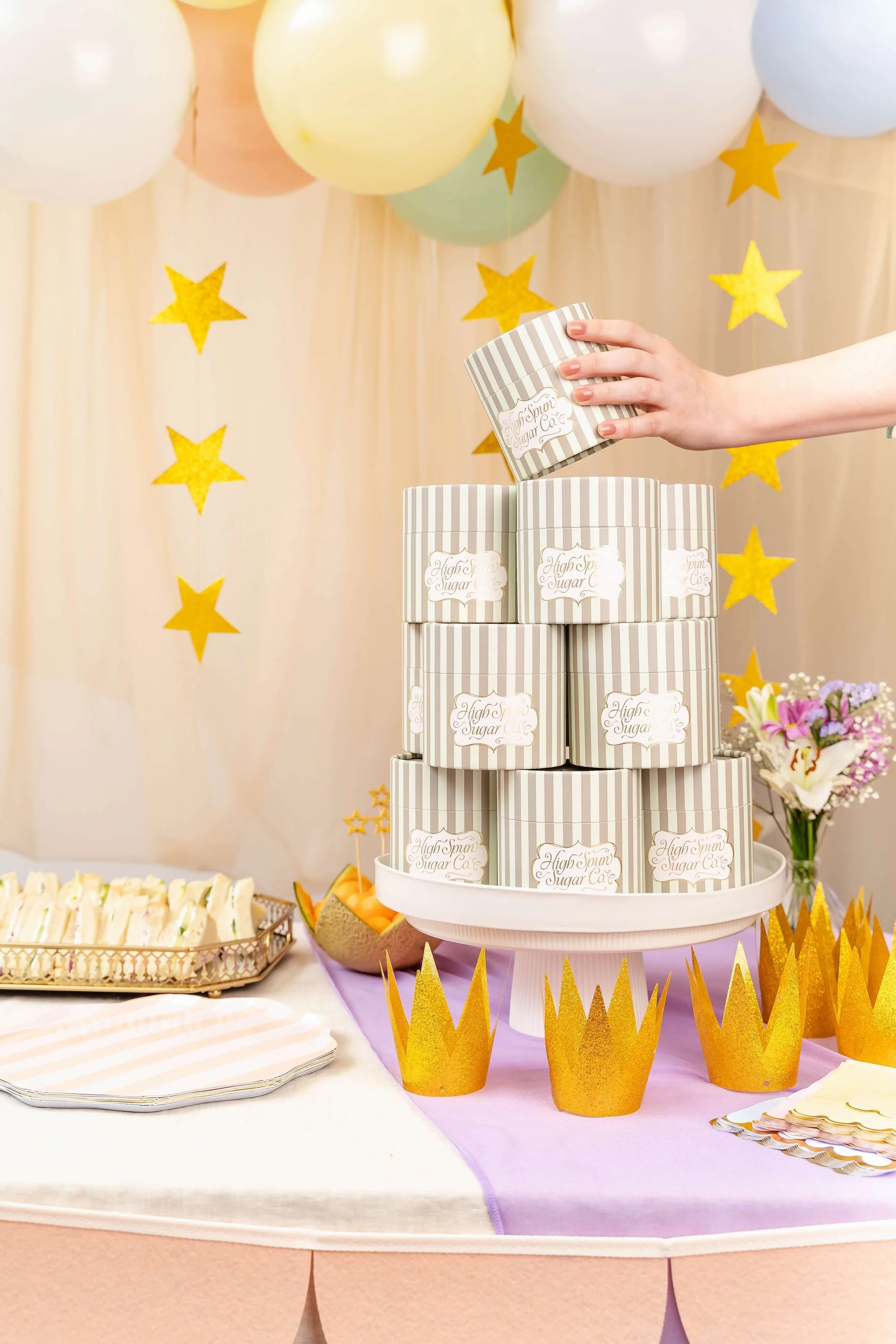 A stack of striped containers in a party scene.