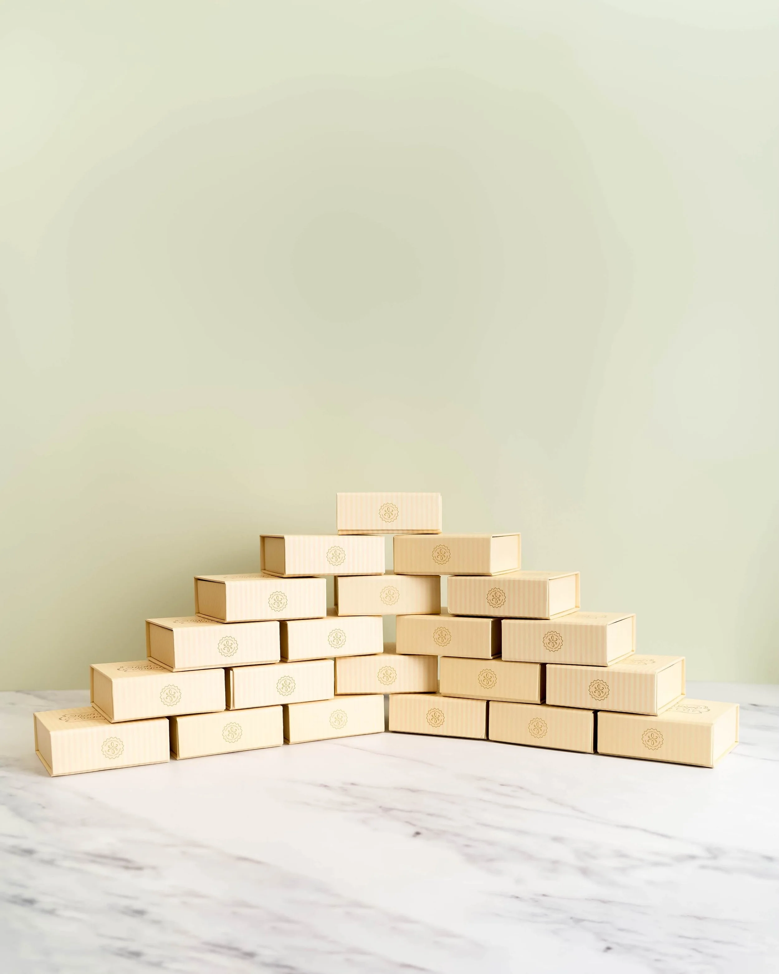 Stacked, beige bite-sized boxes before an olive green background