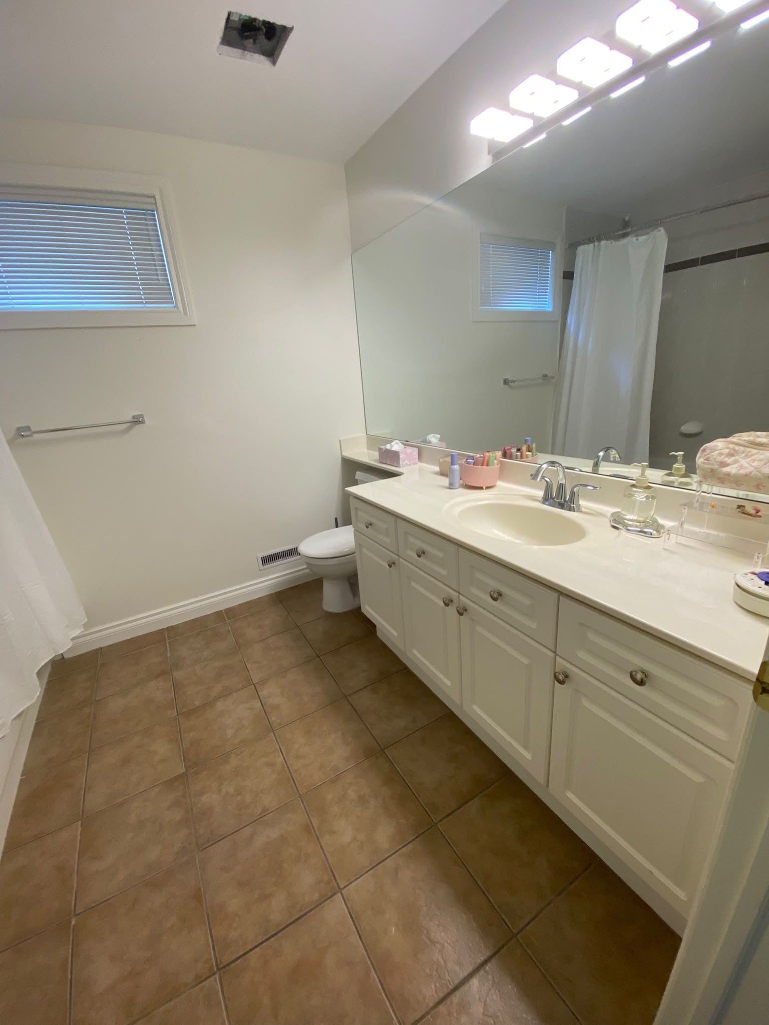 Streak-free mirror and gleaming fixtures in a bathroom cleaned by AAE Home Glow, Calgary house cleaning specialists.