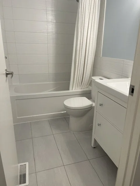 Sparkling clean bathroom with a polished mirror and spotless countertops, serviced by AAE Home Glow in Calgary.