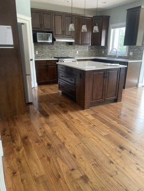 Kitchen island and cabinetry professionally cleaned and sanitized by AAE Home Glow.