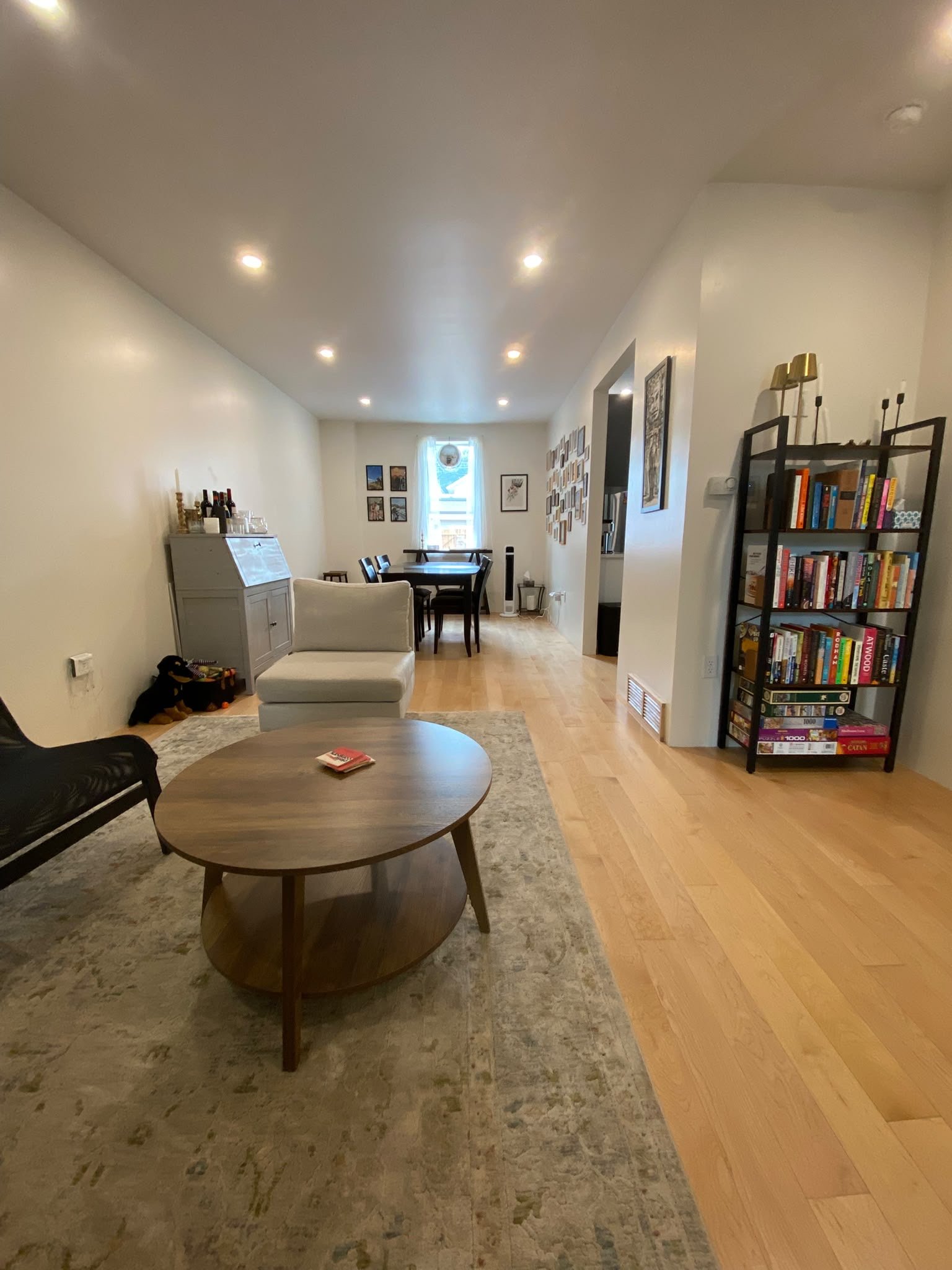Cozy living space with vacuumed rugs and streak-free windows, cleaned by AAE Home Glow.