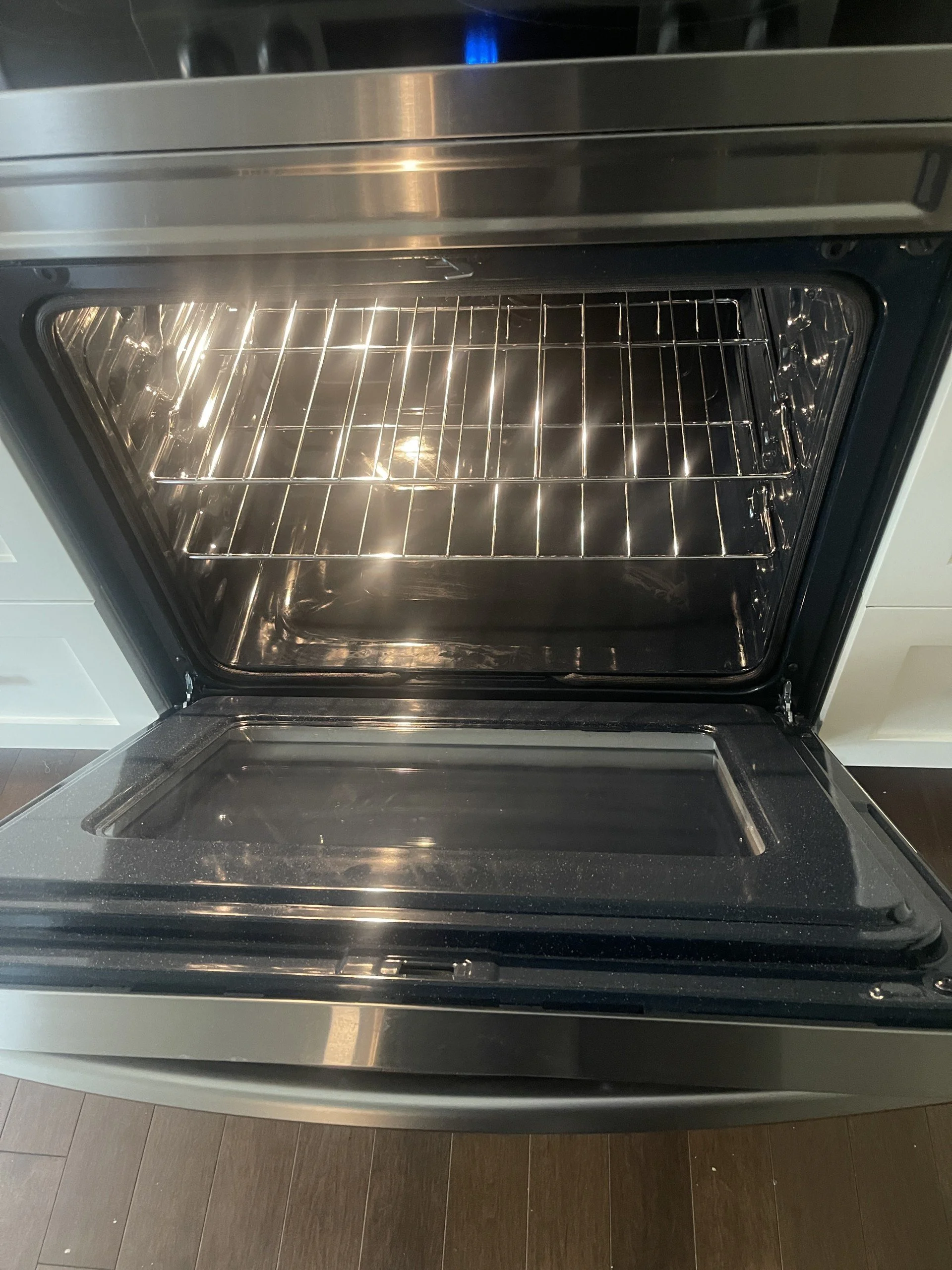 Stovetop and oven interior professionally degreased and sanitized by AAE Home Glow's cleaning team.