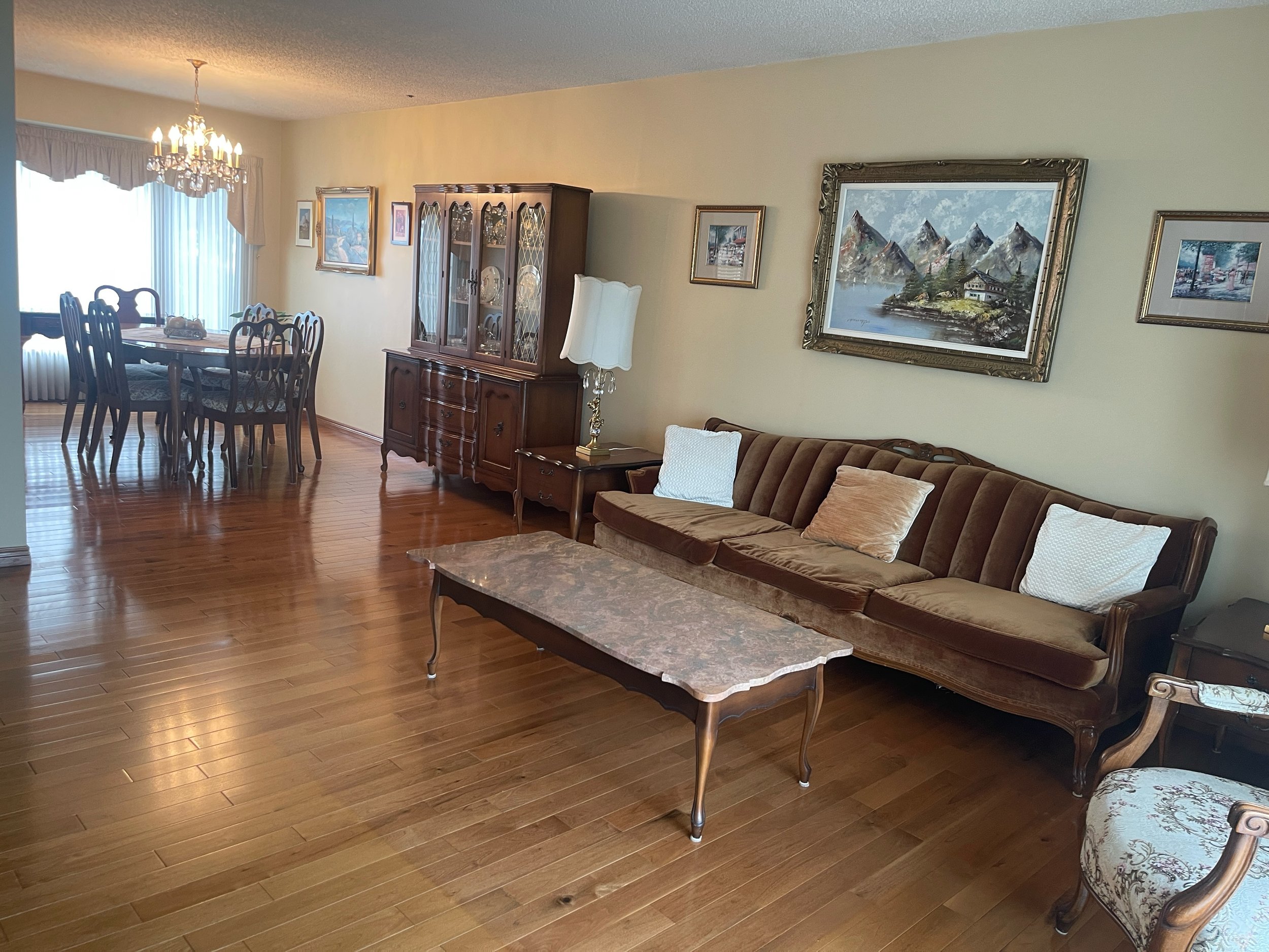 Freshly cleaned living room with dust-free surfaces and vacuumed carpets, serviced by AAE Home Glow in Calgary.