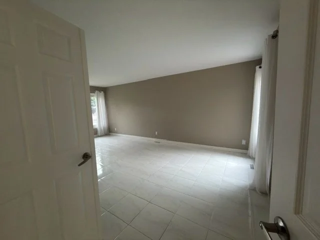 Living area with polished hardwood floors and tidy furniture, cleaned by AAE Home Glow.