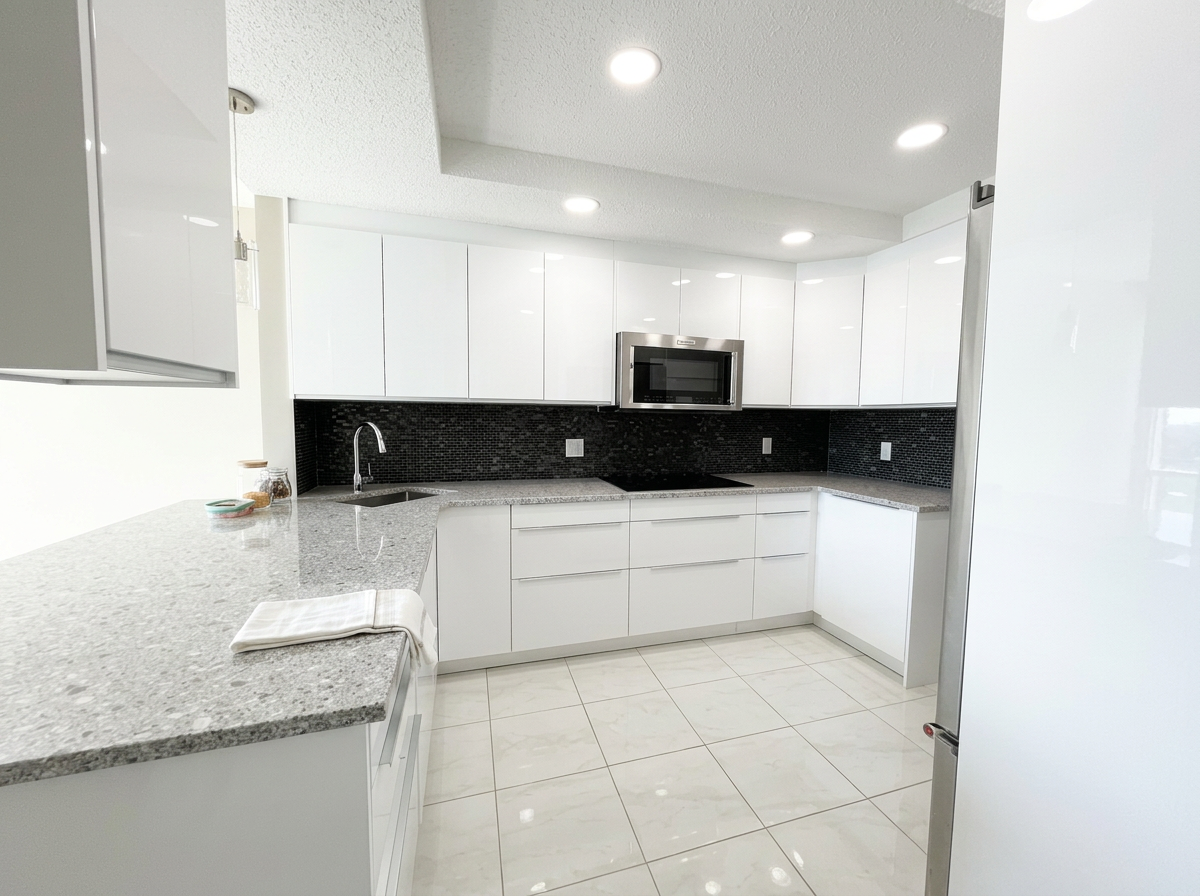 Sparkling clean kitchen after a deep clean by AAE Home Glow, featuring marble backsplash, black cabinets, and stainless steel appliances in a Calgary home.