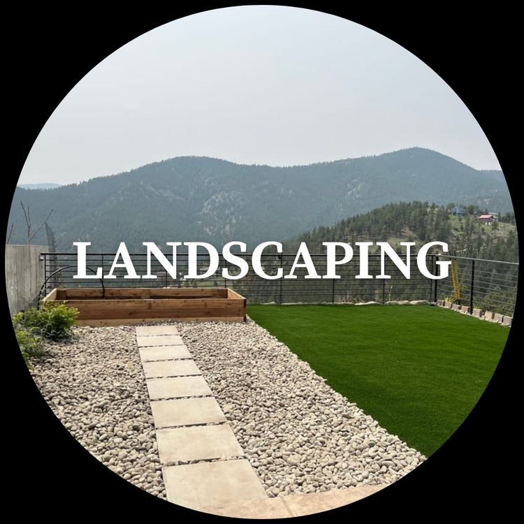 A landscaped backyard with a stone pathway, a gravel area, a small grassy patch, and a view of mountains in the background.