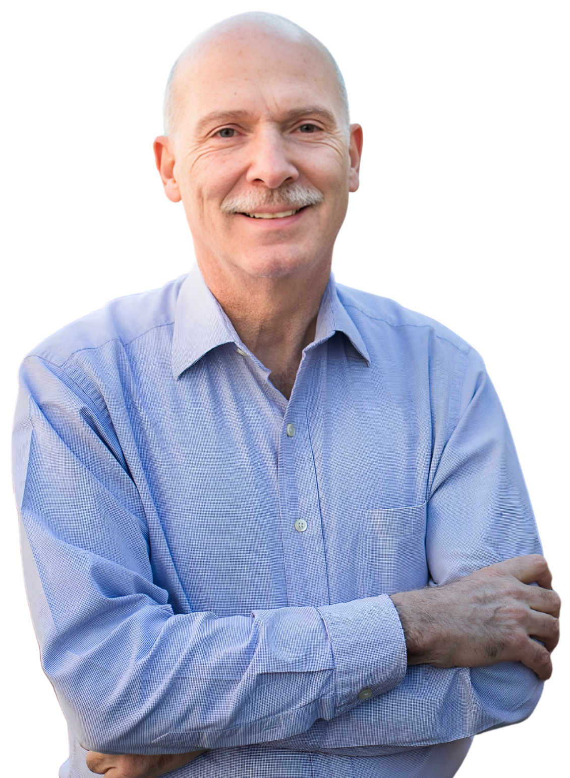 A middle-aged man with a bald head, mustache, and light blue dress shirt stands with arms crossed, smiling at the camera.