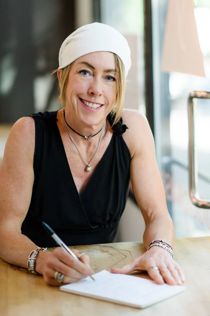 Megan Moseley, owner of Bodywise, sitting at her desk