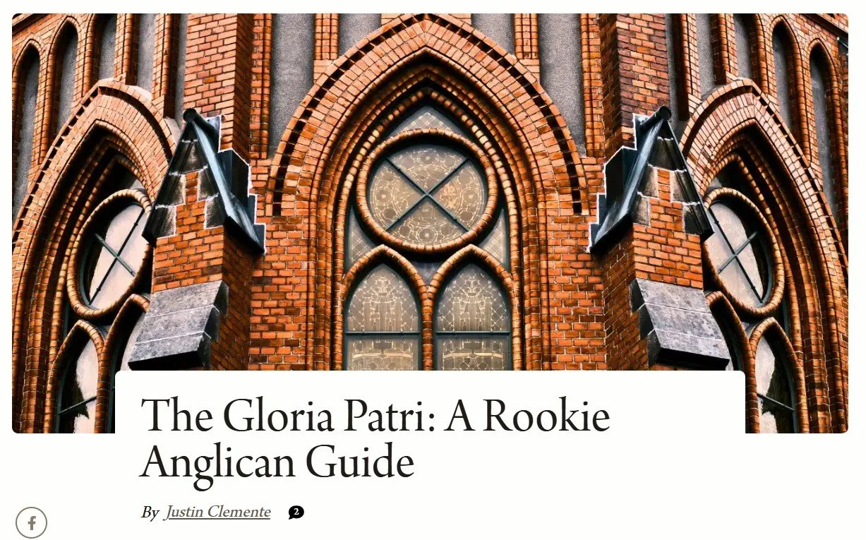 Close-up of a historic brick church with gothic-style pointed arches and decorative stained glass windows.