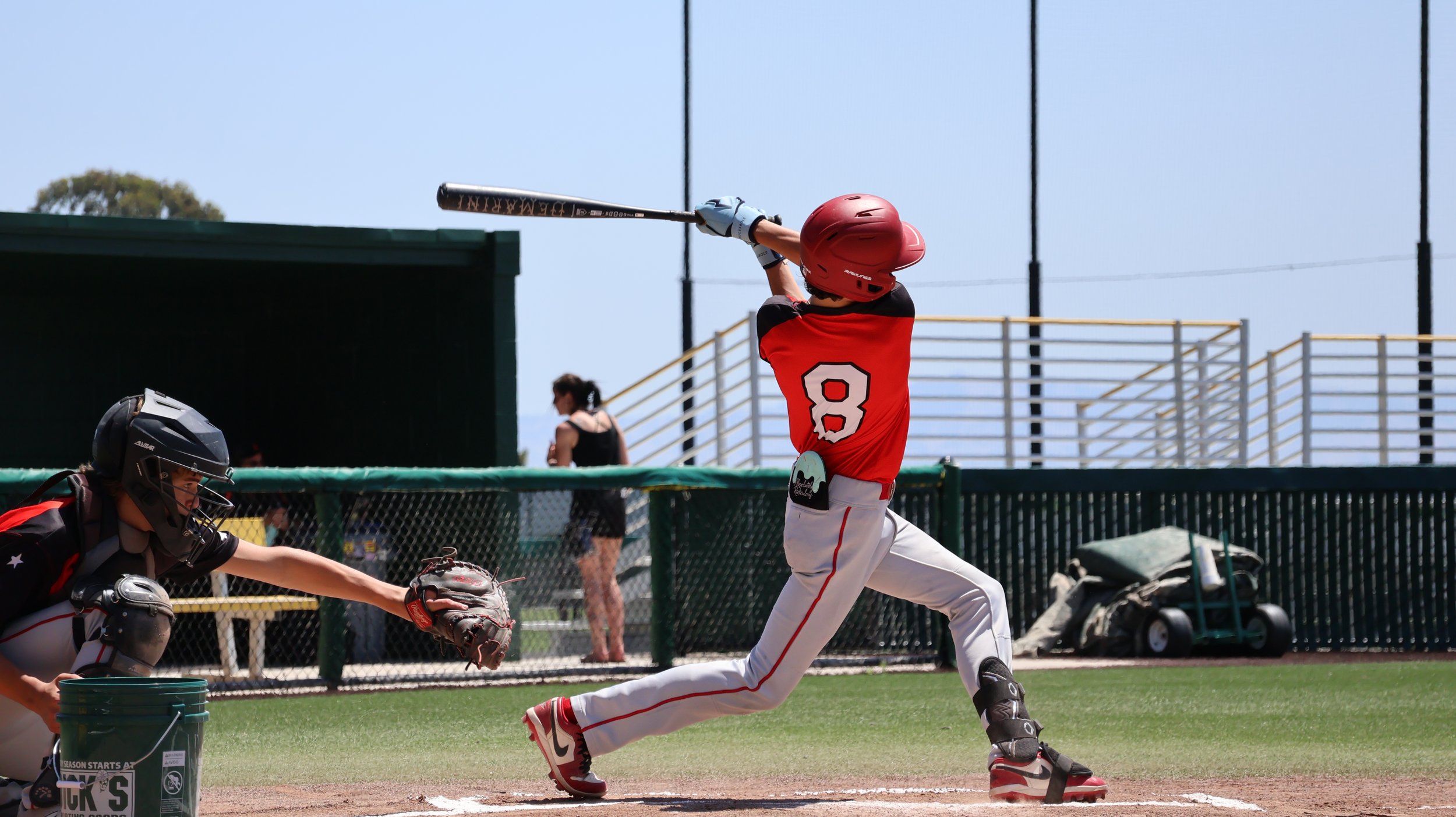 A baseball player swinging a bat at a pitched ball at a baseball game.