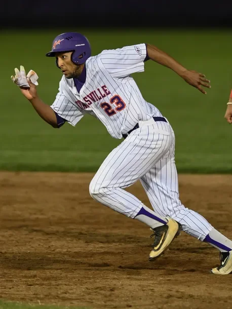 Korbin Williams stealing a base mid-stride during a college game at the University of Evansville.