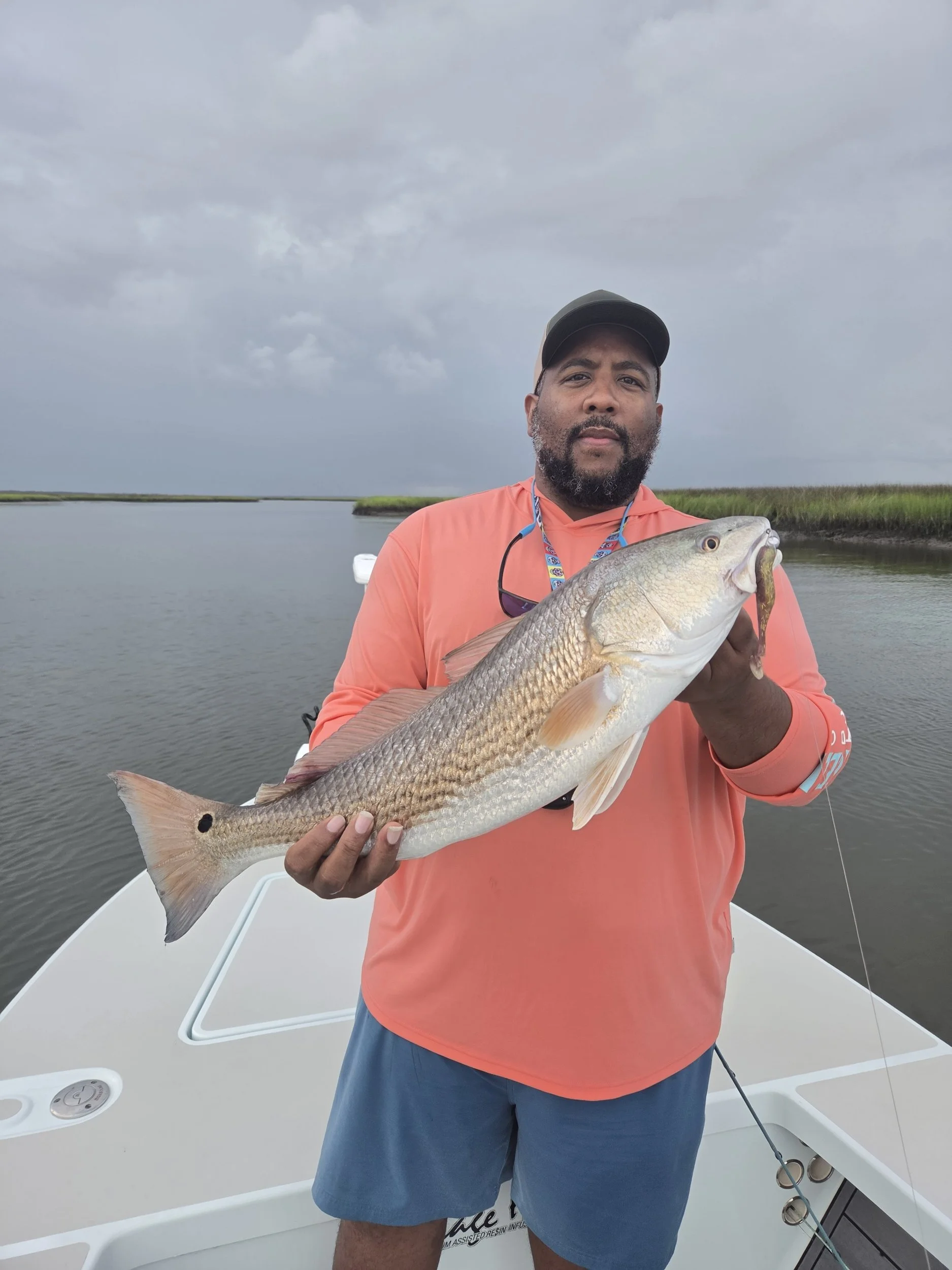 men holding redfish he caught on soft plastic bait by limit out lures 3.8 avenger swimbait 