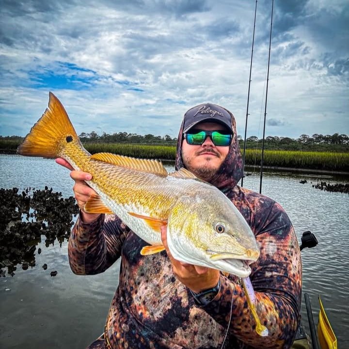Zachary-Prince-holding-Redfish-caught-on-limit-out-lures-custom-soft-plastic-bait-guava-pumpkin-seed..jpg