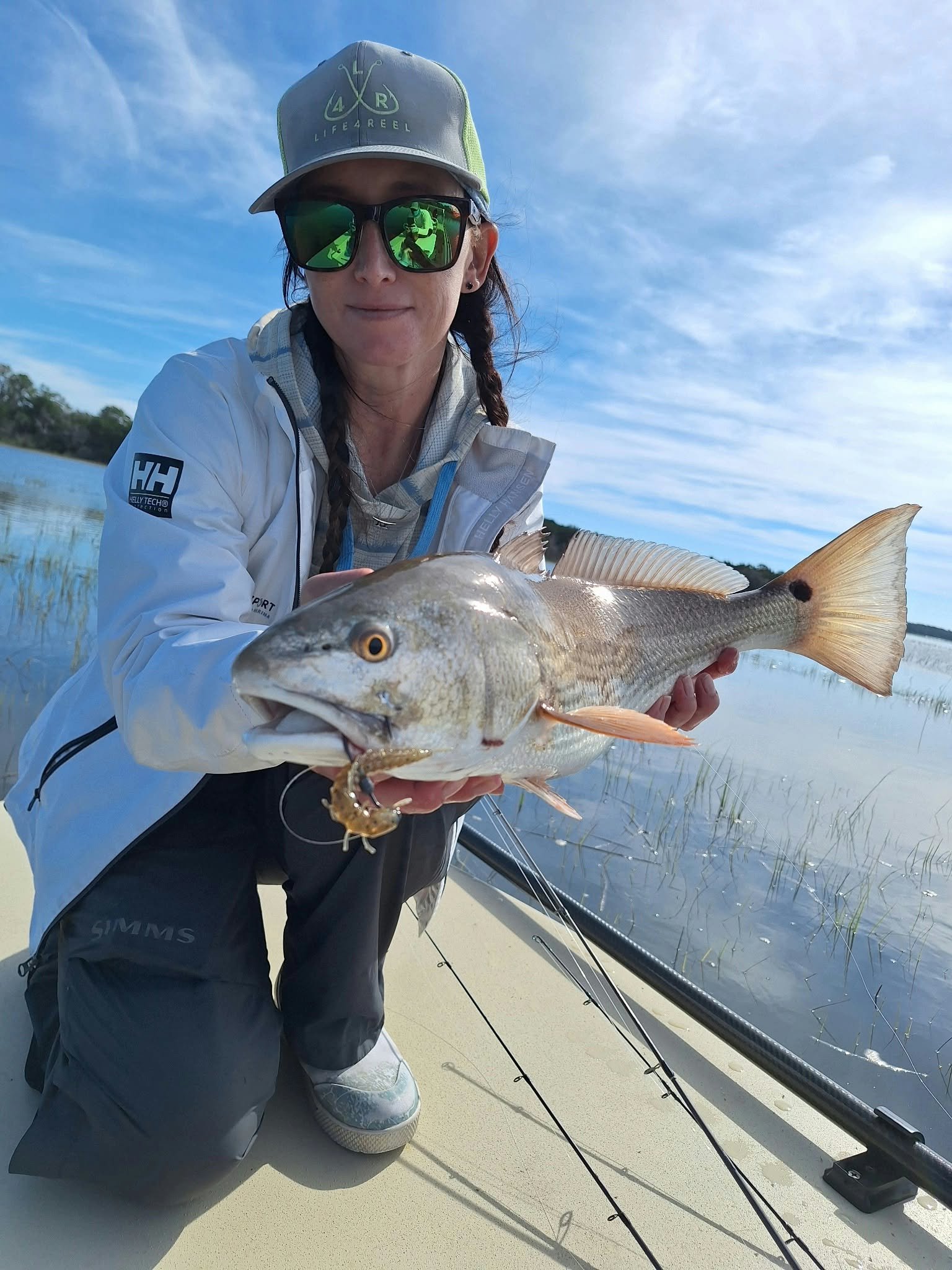 Tournament Lady Angler Courtney reeling in a nice slot redfish on the 3-inch hellgrammite from limit out lures 