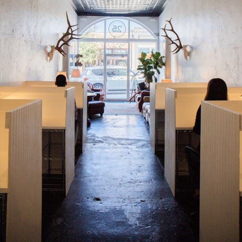 The interior of the Creative Covey, a co-working office space with rows of wooden study cubicles