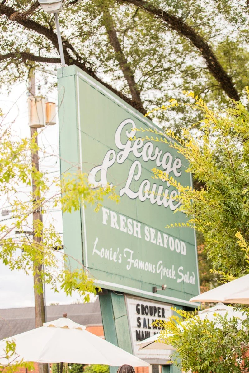 Green sign for George & Louie's Fresh Seafood in Thomasville, advertising their famous Greek salad