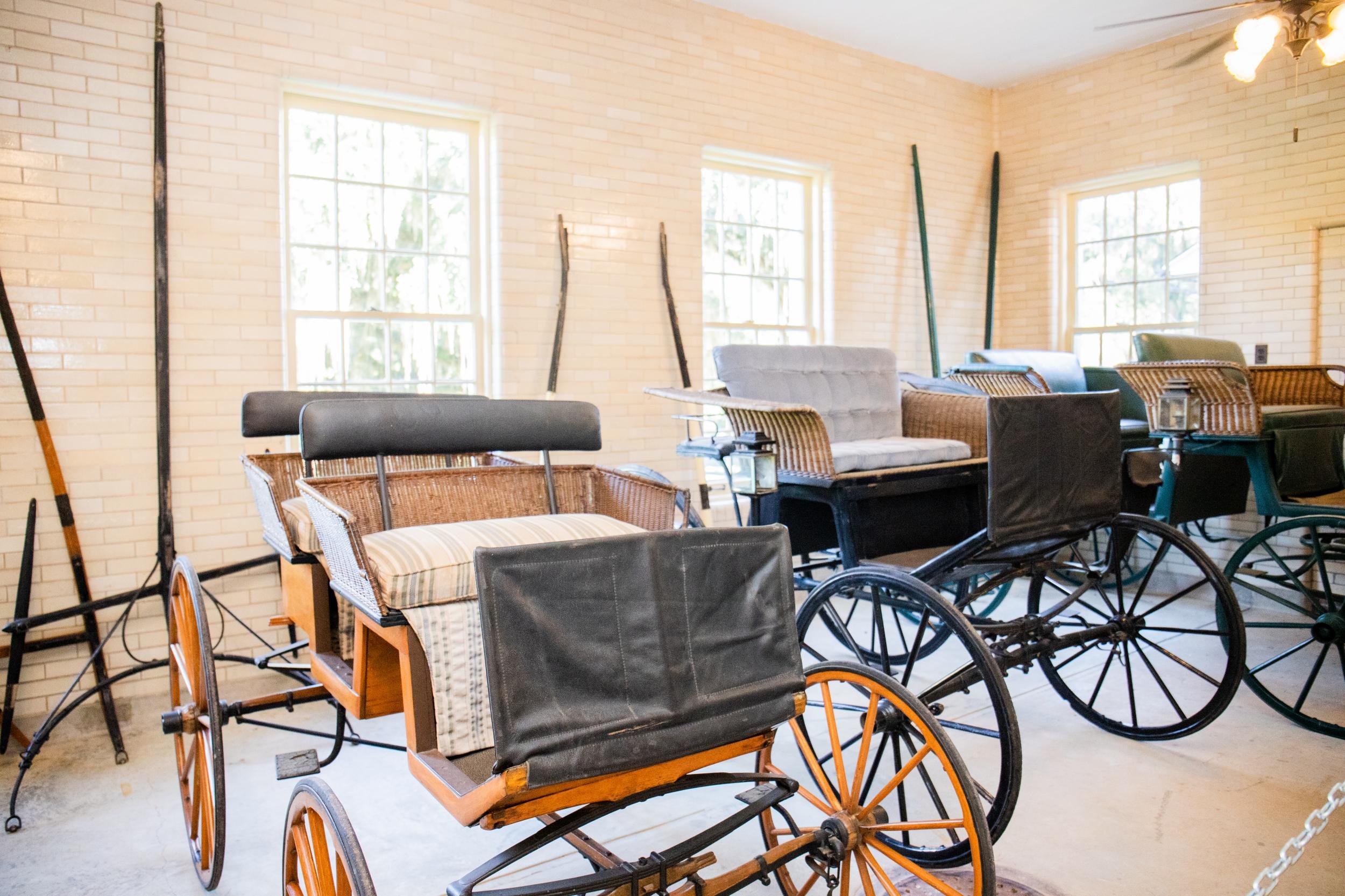 A room with several wheelchairs along with a variety of chairs, including wicker and cushioned seats