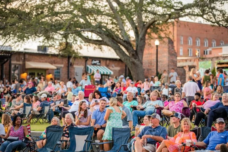 a lively outdoor concert at the Ritz Amphitheater with a large crowd