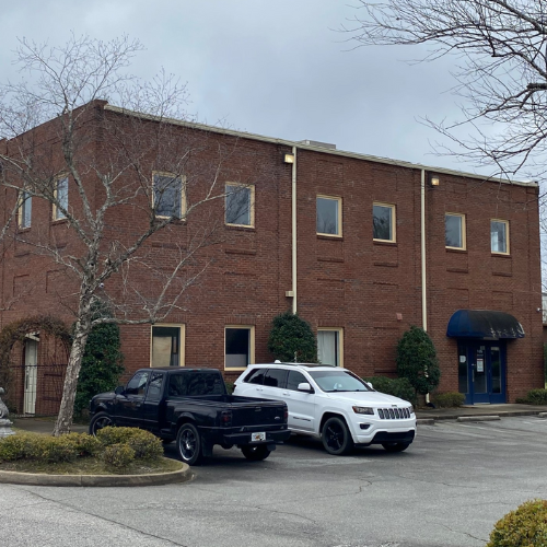 A two-story red brick office building at 106 Oak Street in Thomasville, GA