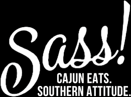 Black logo on white backdrop: cursive "Sass!" above text "CAJUN EATS. SOUTHERN ATTITUDE."