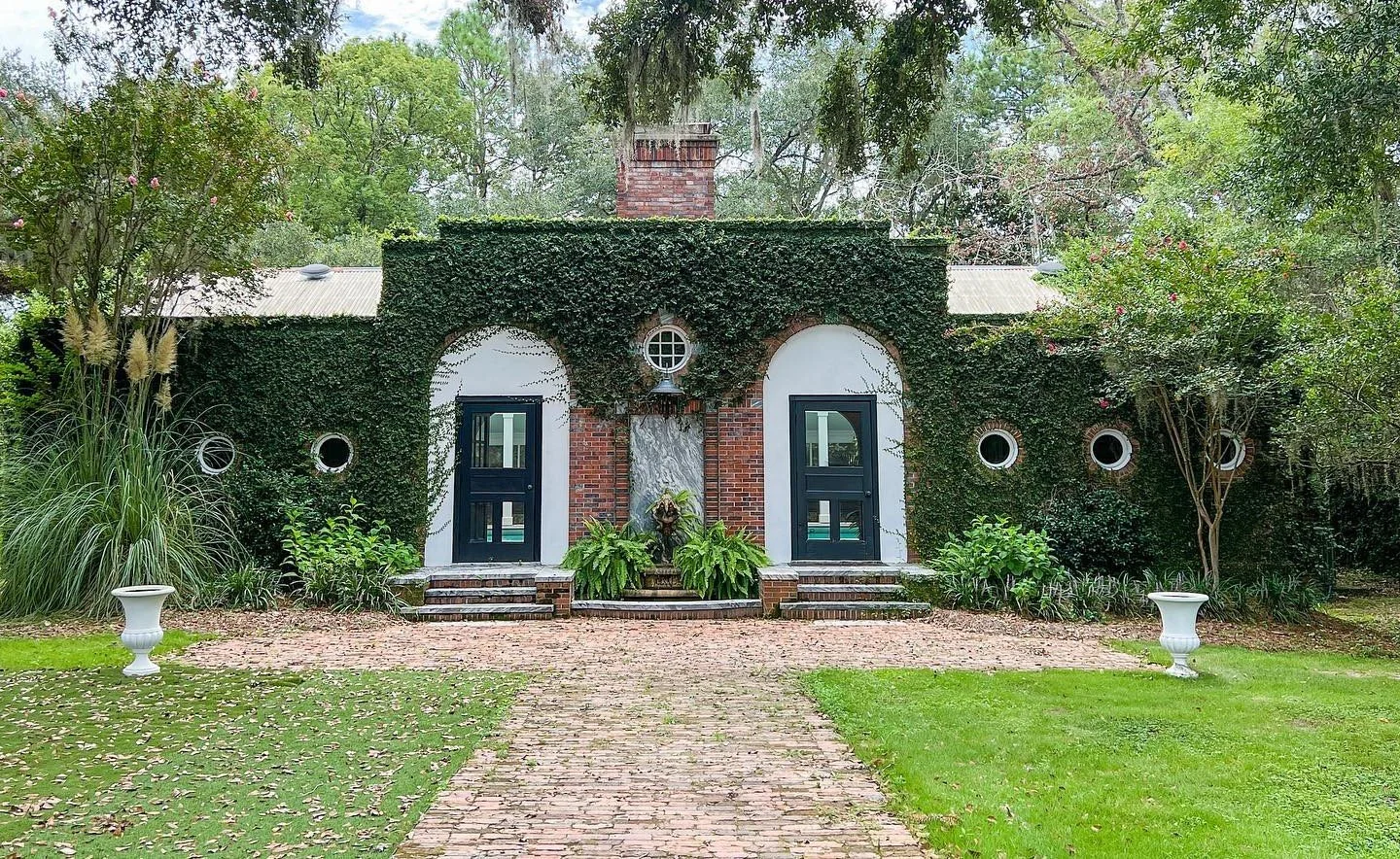 South Eden Plantation, a vine-covered brick house with arched doors and a brick pathway