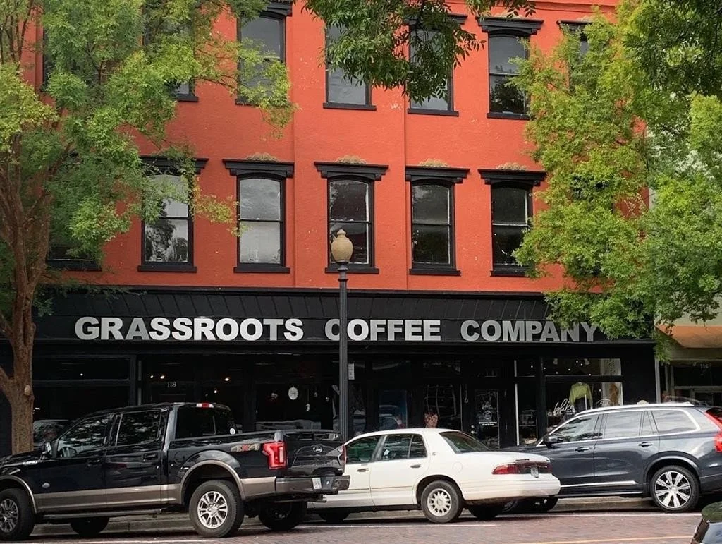 Grassroots Coffee Company storefront in a historic, three-story red brick building