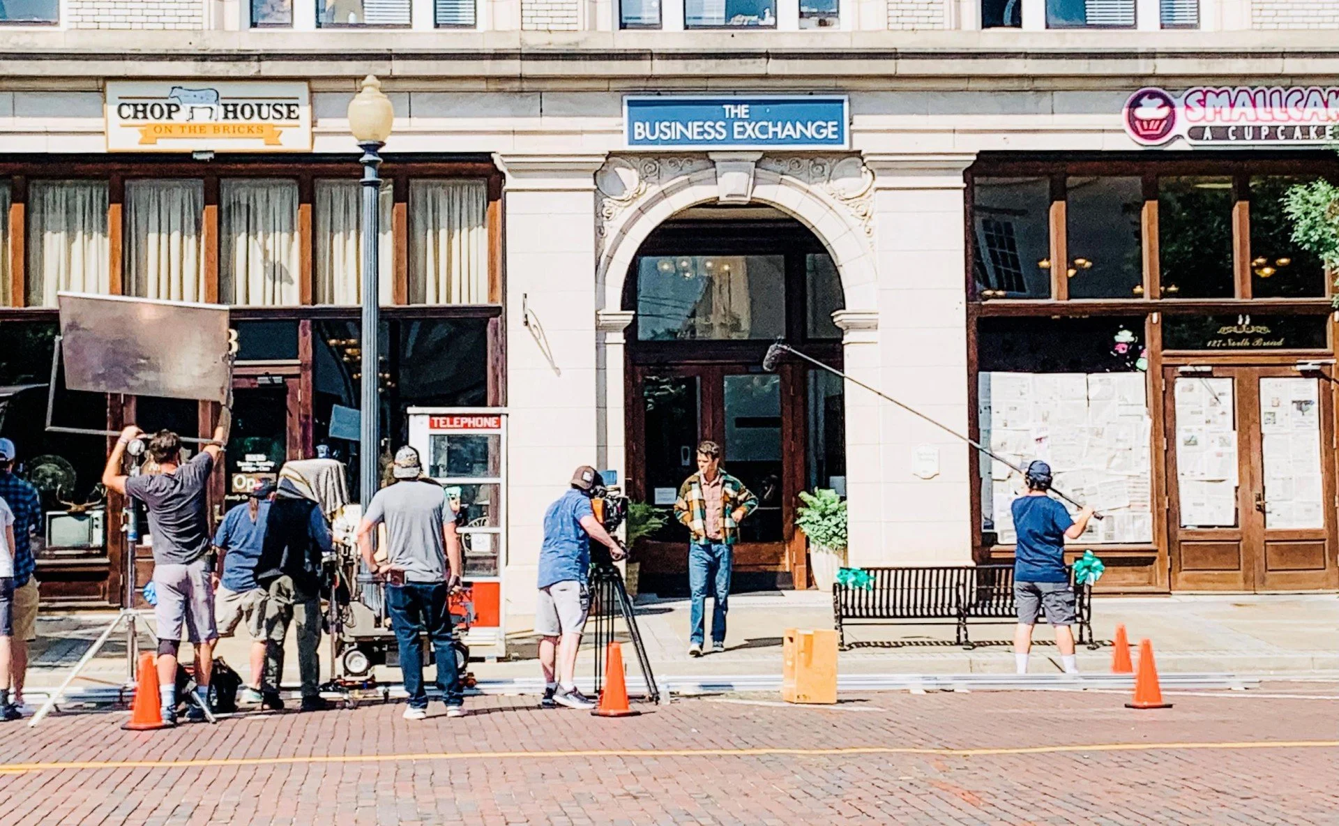 City street film shoot outside Chop House, The Business Exchange, and Smallcakes