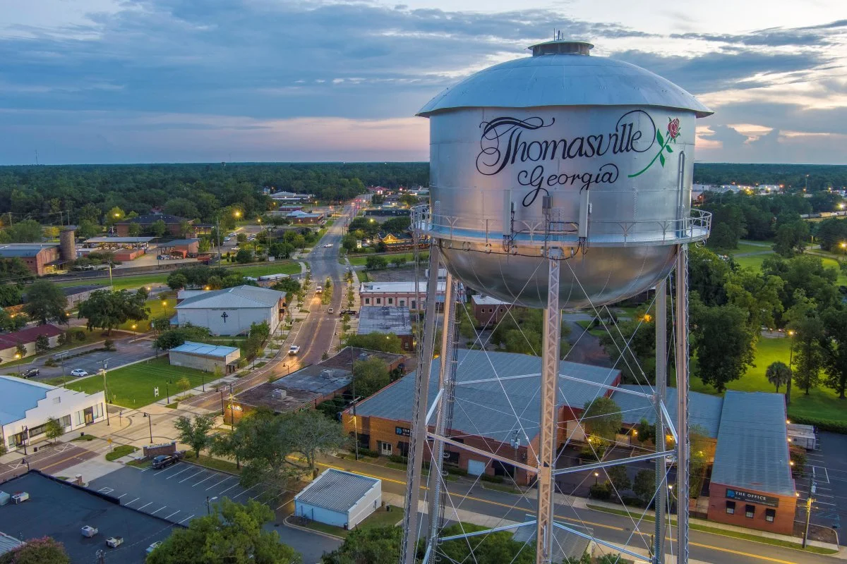Aerial view of Thomasville showing a water tower with the city's name and a rose painted on it