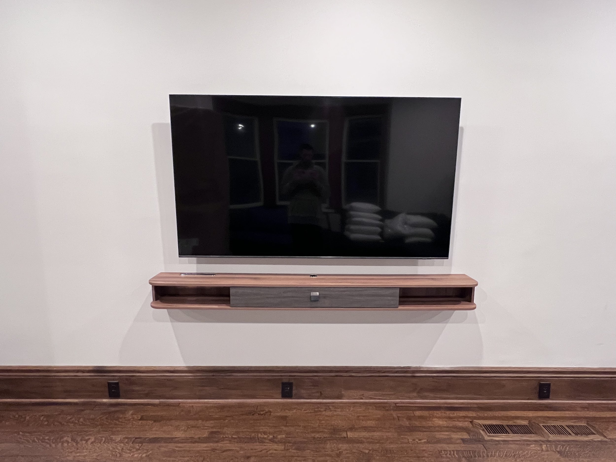 Wall-mounted TV professionally installed in a recovery home living space in St. Paul, Minnesota