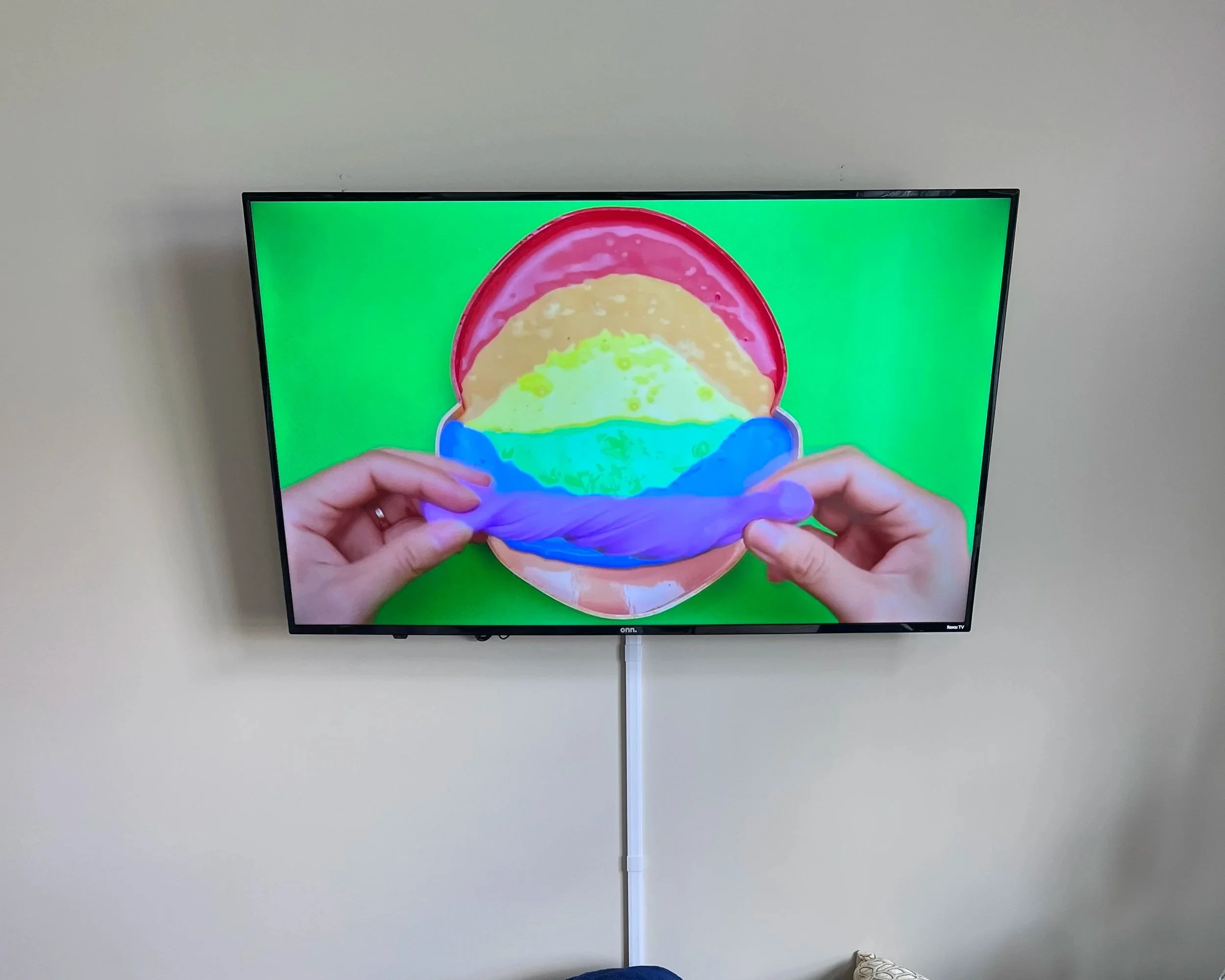 Wall-mounted TV with cord concealment raceways for a clean install by a handyman in Blaine, Minnesota