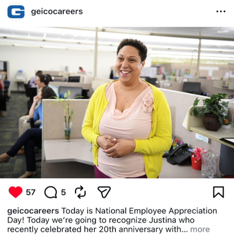 Woman smiling and standing in an office cubicle.