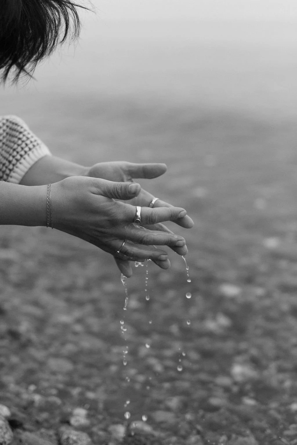 Niki Kairis with water slipping through her hands The Vancouver Death Doula