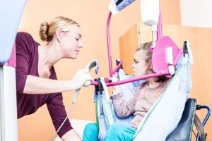 A healthcare worker speaking to a young girl in a medical setting