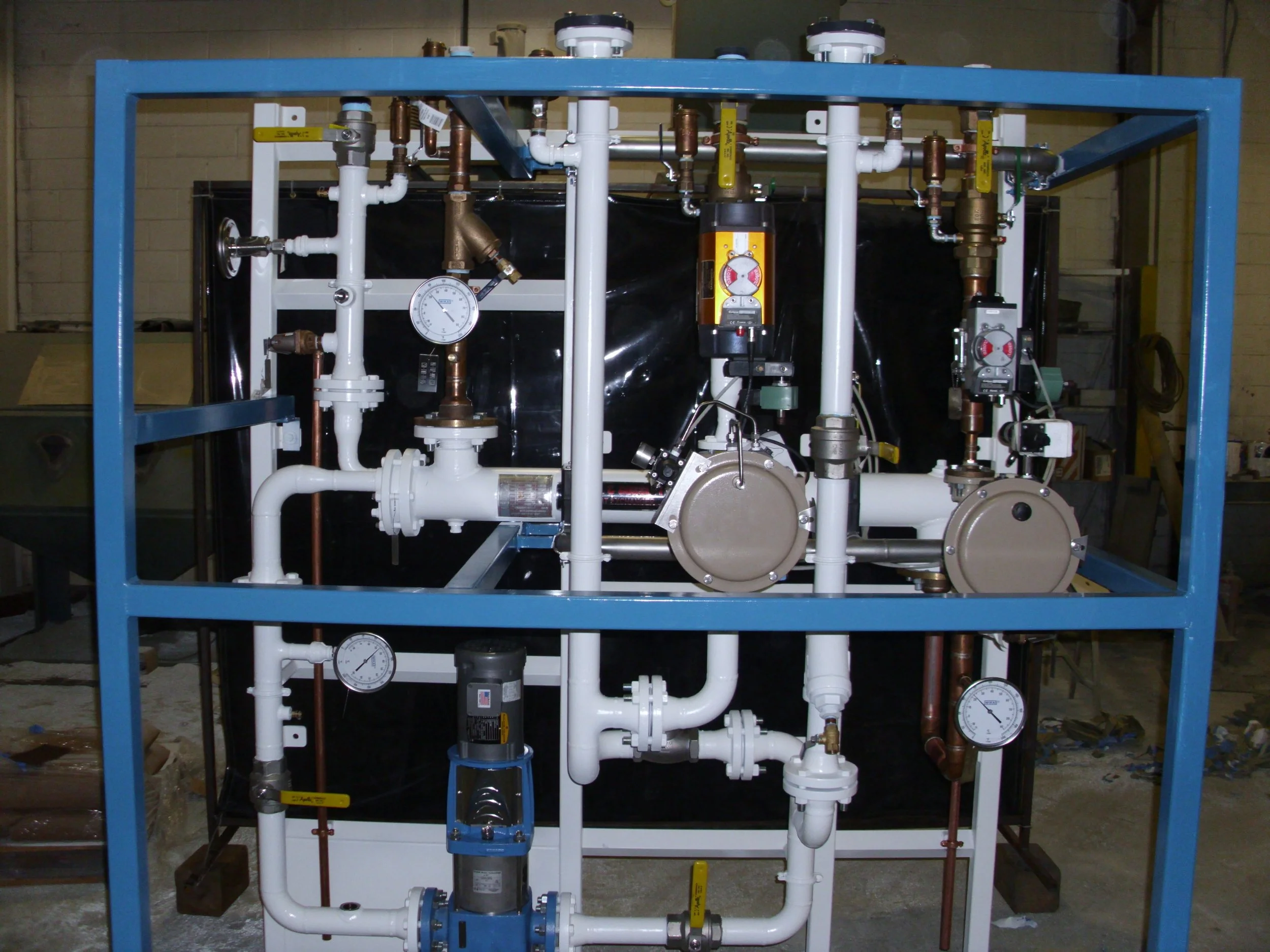 Industrial pump and piping system with gauges and valves mounted on a blue metal frame.