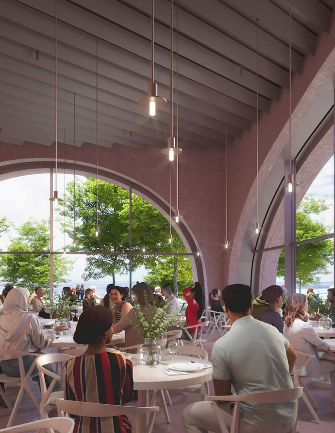 A vibrant restaurant interior with large arched windows overlooking a green, outdoor landscape and a body of water. The room is filled with people dining, and there's modern pendant lighting hanging from a ceiling with exposed beams.