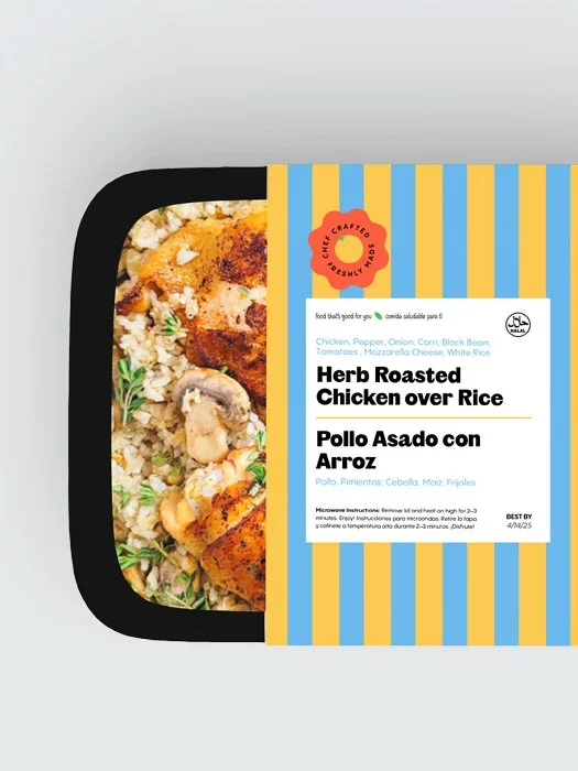 Frozen herb roasted chicken over rice meal and its packaging with blue and yellow stripes, showing ingredients like chicken, pepper, onion, corn, and rice.