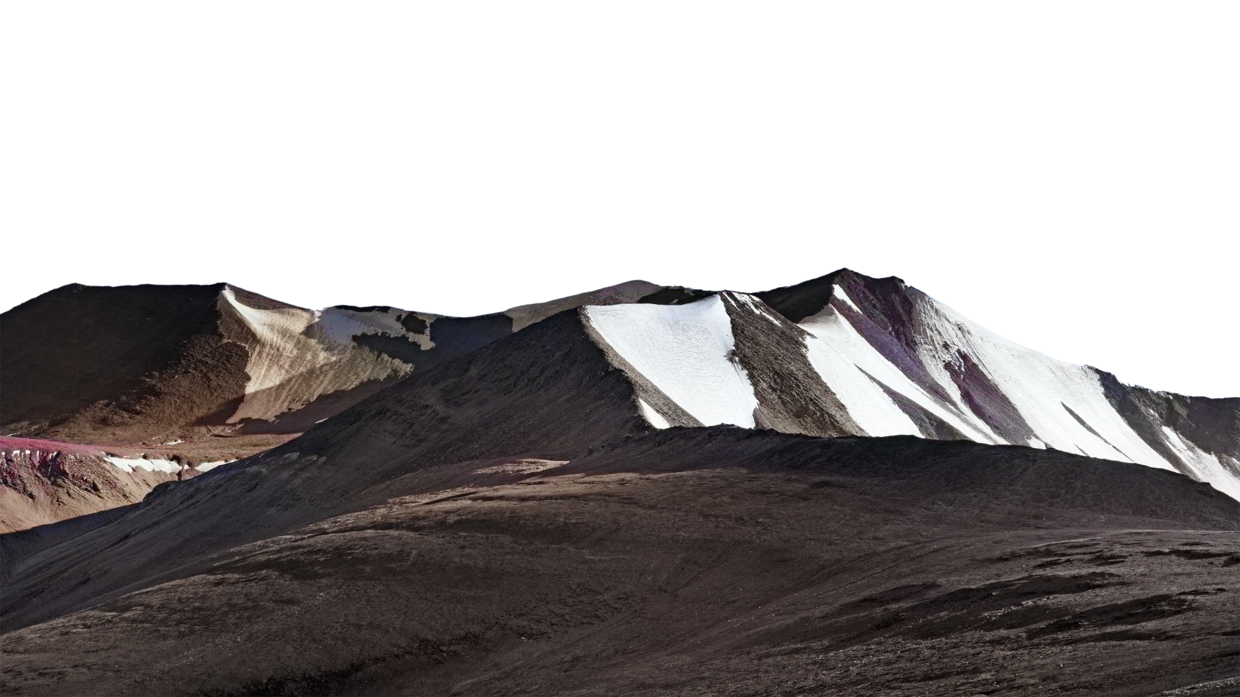 A mountain range with snow patches on dark rocky slopes under a black sky.