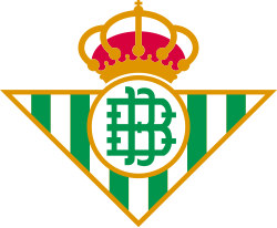 The logo of Real Betis Balompié, a football club, featuring a crown above a shield with green and white stripes and a circle with initials.
